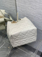 Dior quilted white barrel bag with top handle and gold clasp