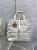 Dior quilted white tote bag with top handles and gold charm detail