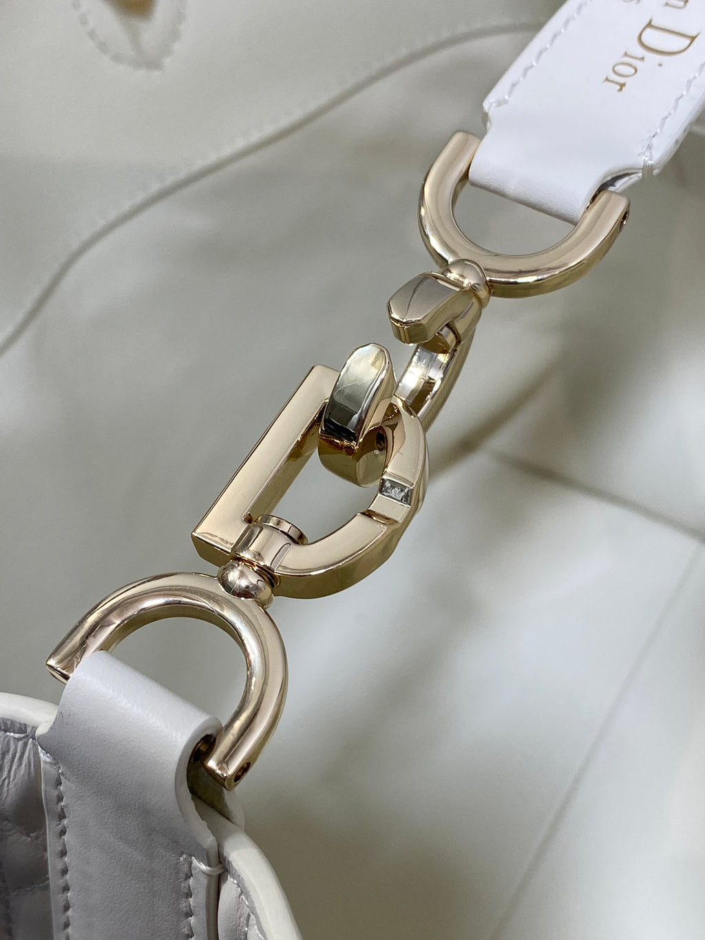 Dior white bag strap with gold swivel clasp and hardware detail