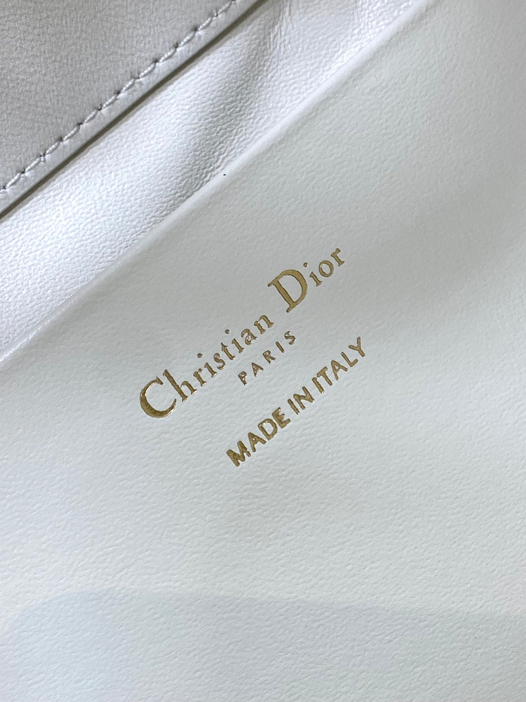 Dior “Christian Dior” and “MADE IN ITALY” stamp on white leather