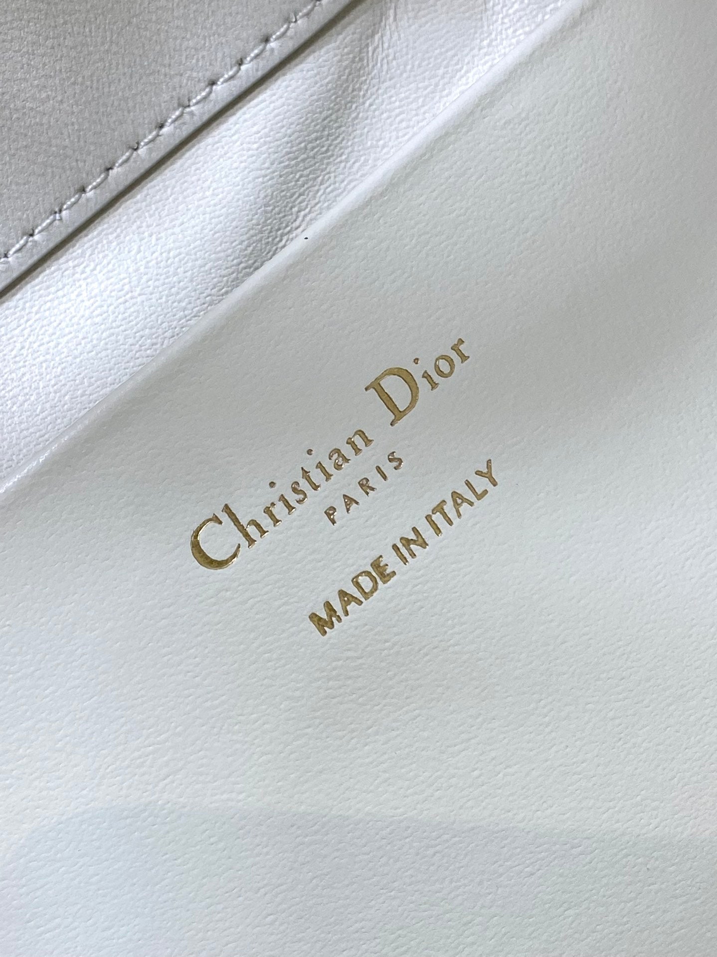 Dior “Christian Dior” and “MADE IN ITALY” stamp on white leather