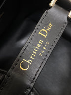 Dior 'Christian Dior Paris' text on black leather strap edge