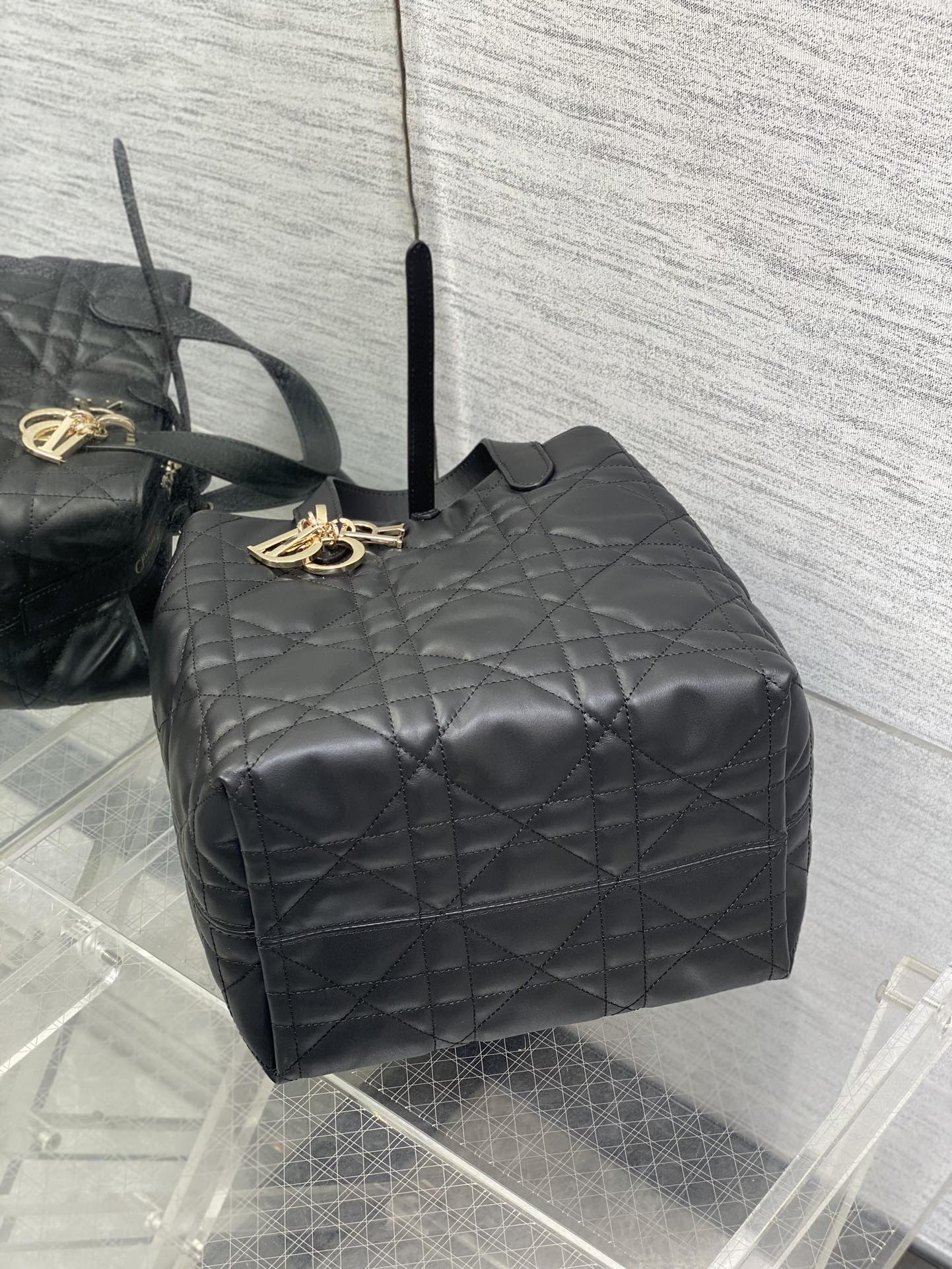 Dior quilted leather top handle bag, black with gold logo charm