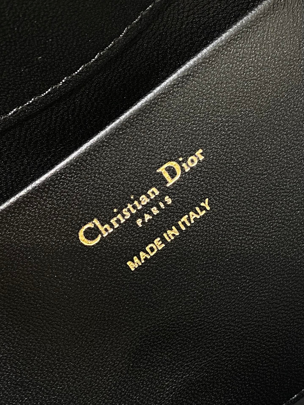 Dior 'Christian Dior Paris' and 'MADE IN ITALY' on black leather
