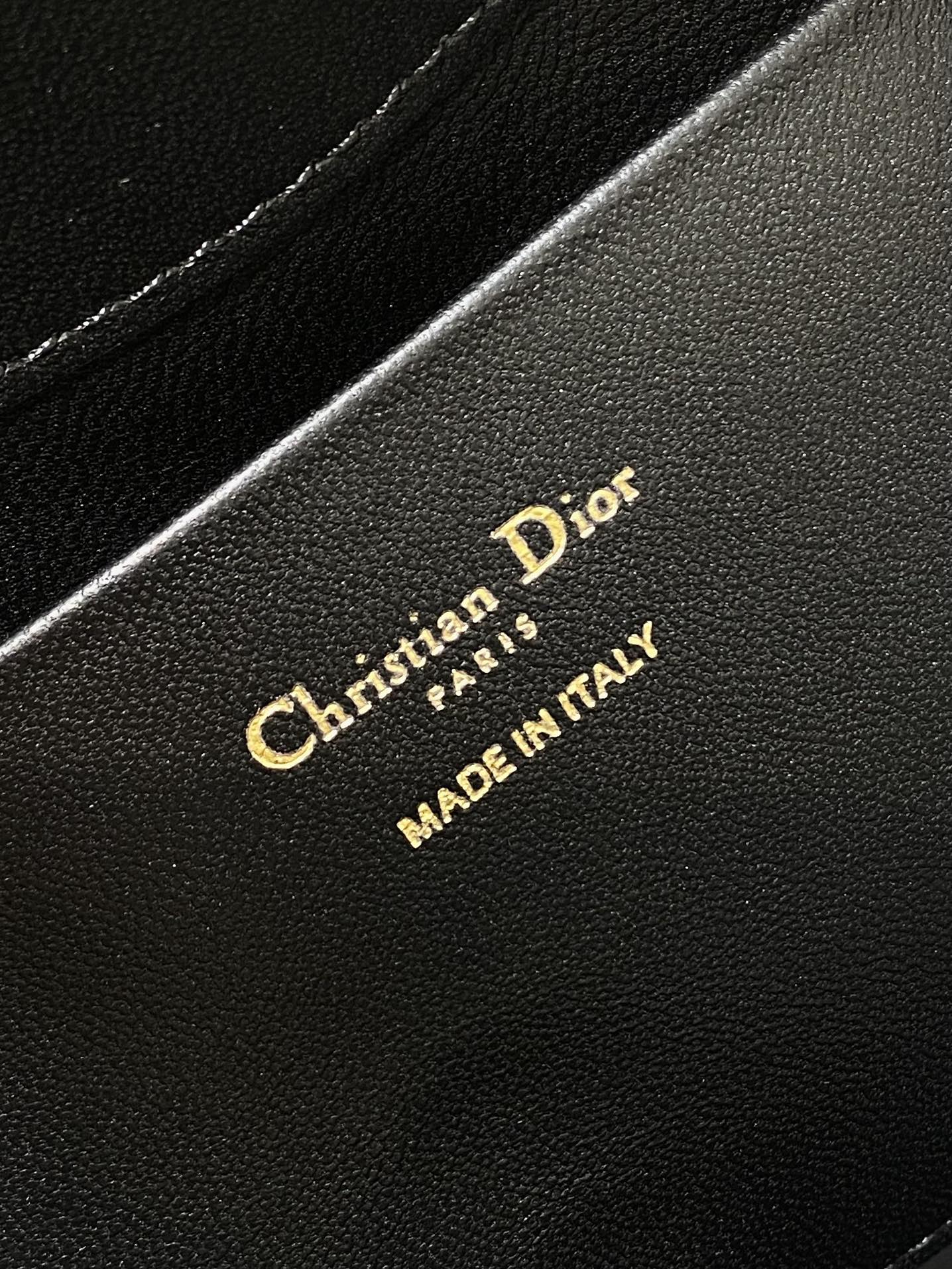 Dior 'Christian Dior Paris' and 'MADE IN ITALY' on black leather