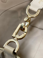 Dior cream handbag clasp hardware with gold-tone hook and ring attachment