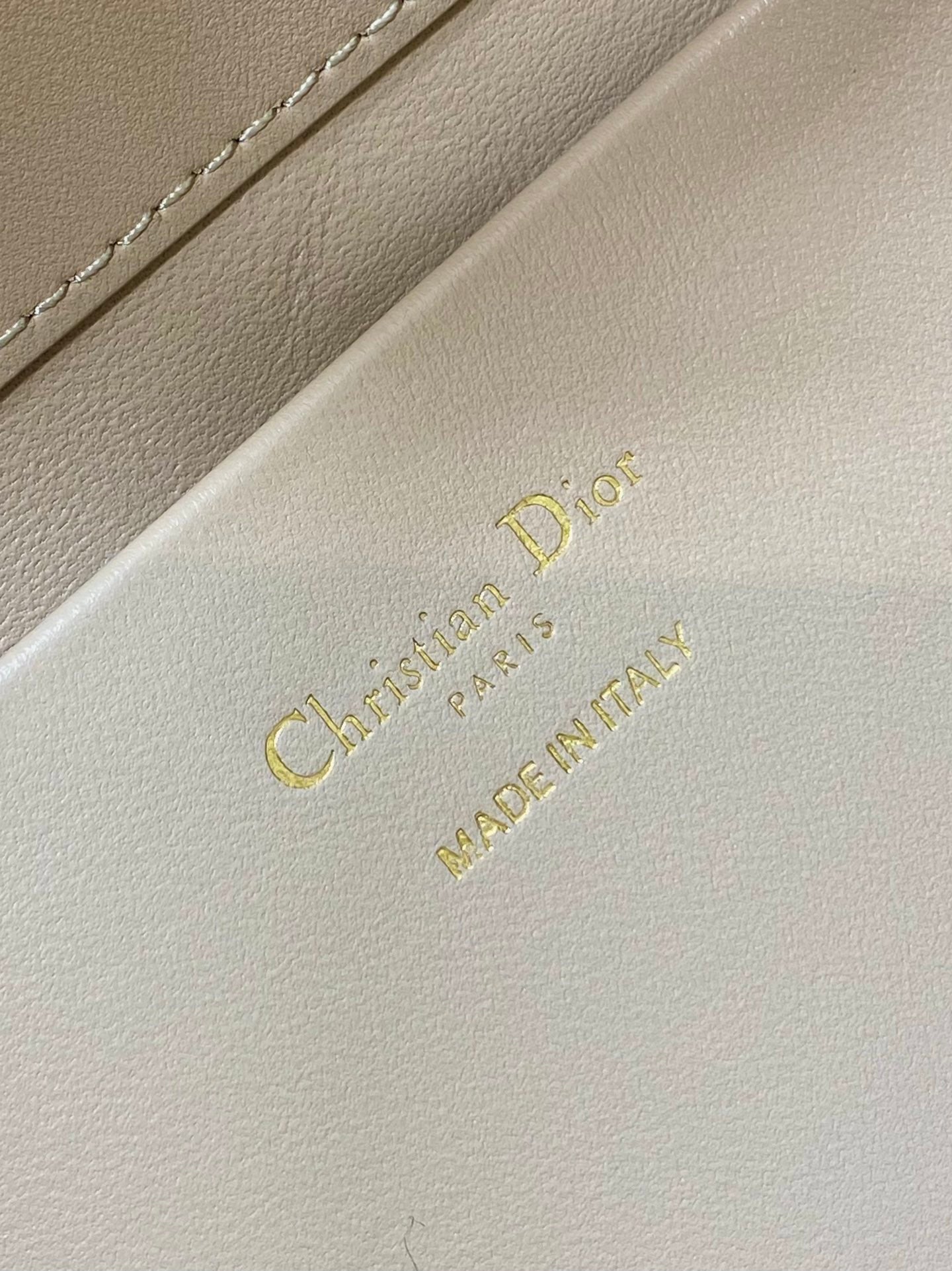 Dior cream leather branding label reading “Christian Dior” and “MADE IN FRANCE”