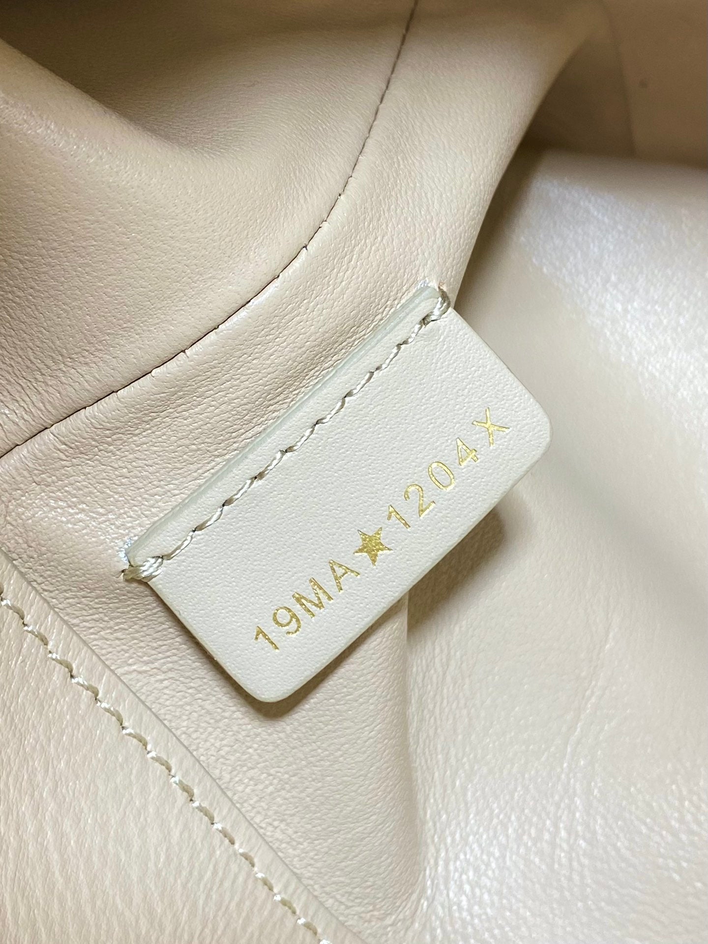 Dior cream handbag interior leather patch label with gold “Dior” text