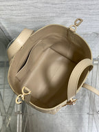 Dior cream handbag interior view with open top, inner lining, and gold-tone rings