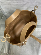 Beige Dior mini handbag open top with shoulder strap and gold-tone zipper pull