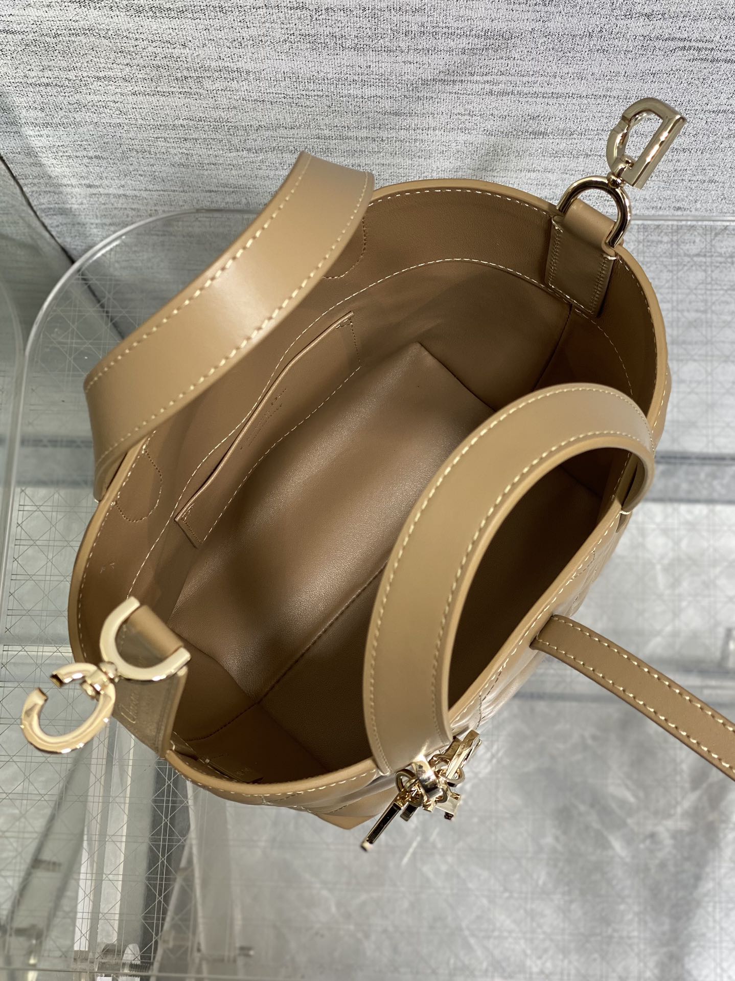 Beige Dior mini handbag open top with shoulder strap and gold-tone zipper pull