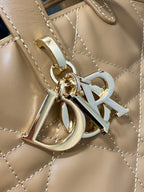 Dior handbag logo hardware detail with metal rings and strap attachment