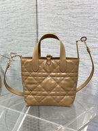 Dior quilted mini handbag with shoulder strap, top handle, and gold-tone hardware
