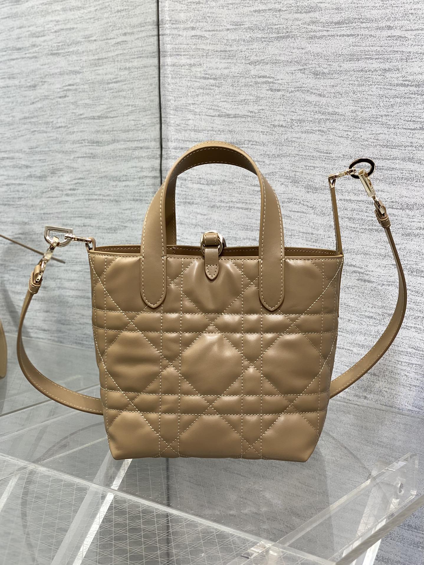 Dior quilted mini handbag with shoulder strap, top handle, and gold-tone hardware