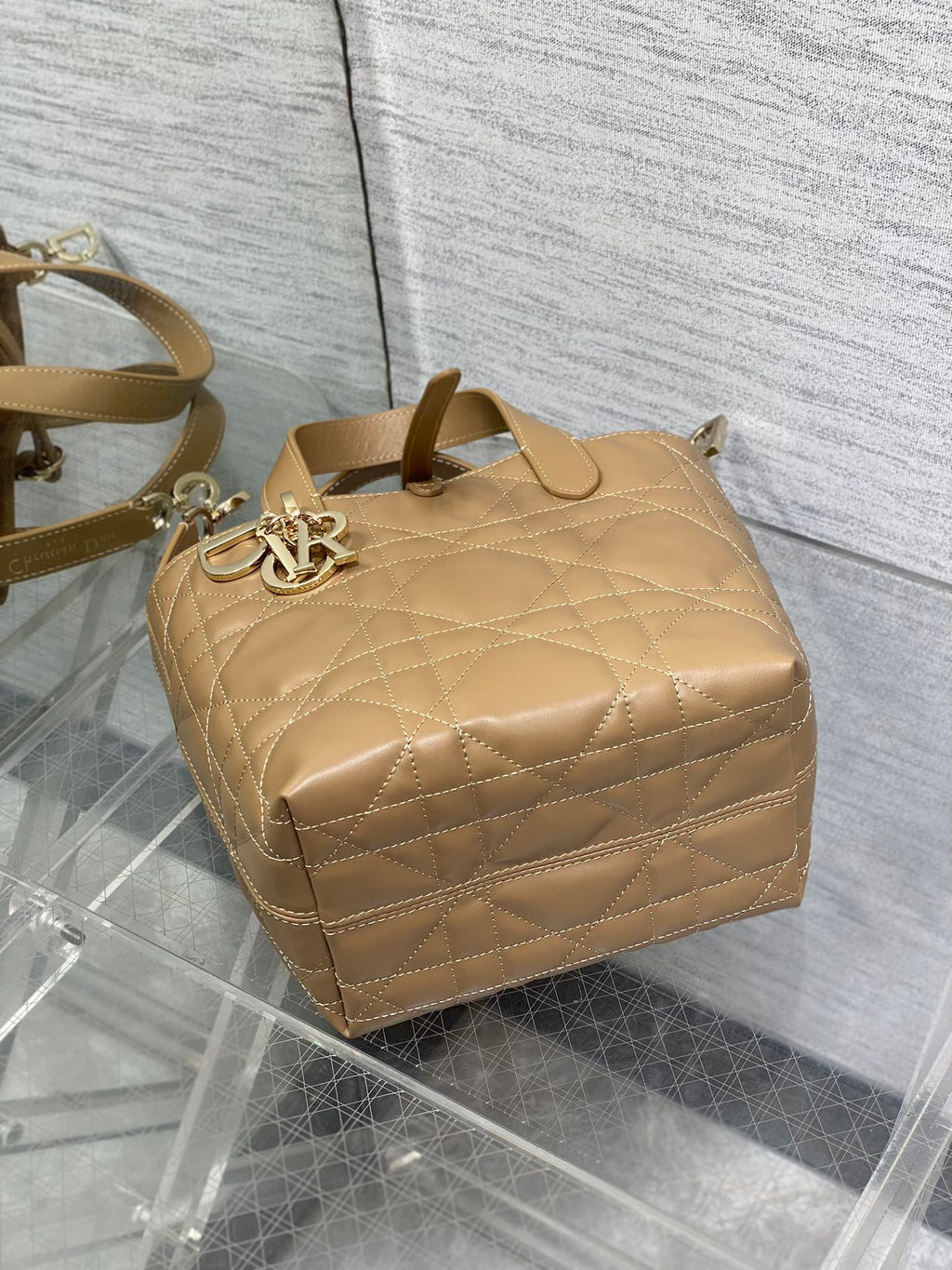 Quilted Dior mini handbag with top handles and gold-tone logo ring, beige