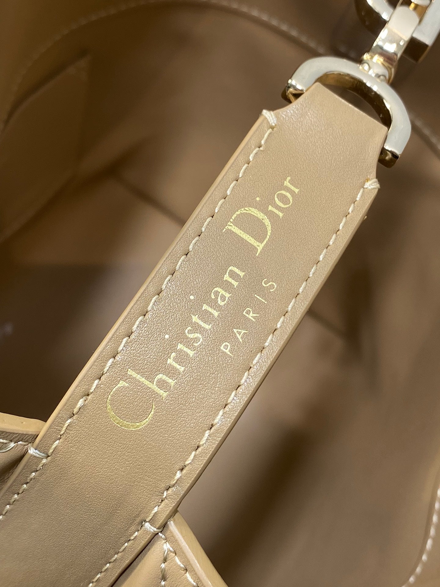Beige Dior strap label with stitched 'Christian Dior Paris' lettering