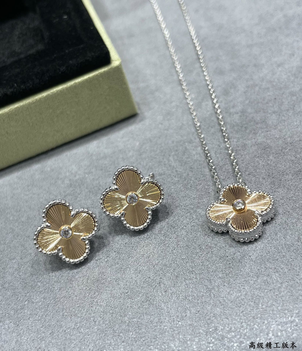 Silver-tone clover flower pendant necklace and matching stud earrings set.