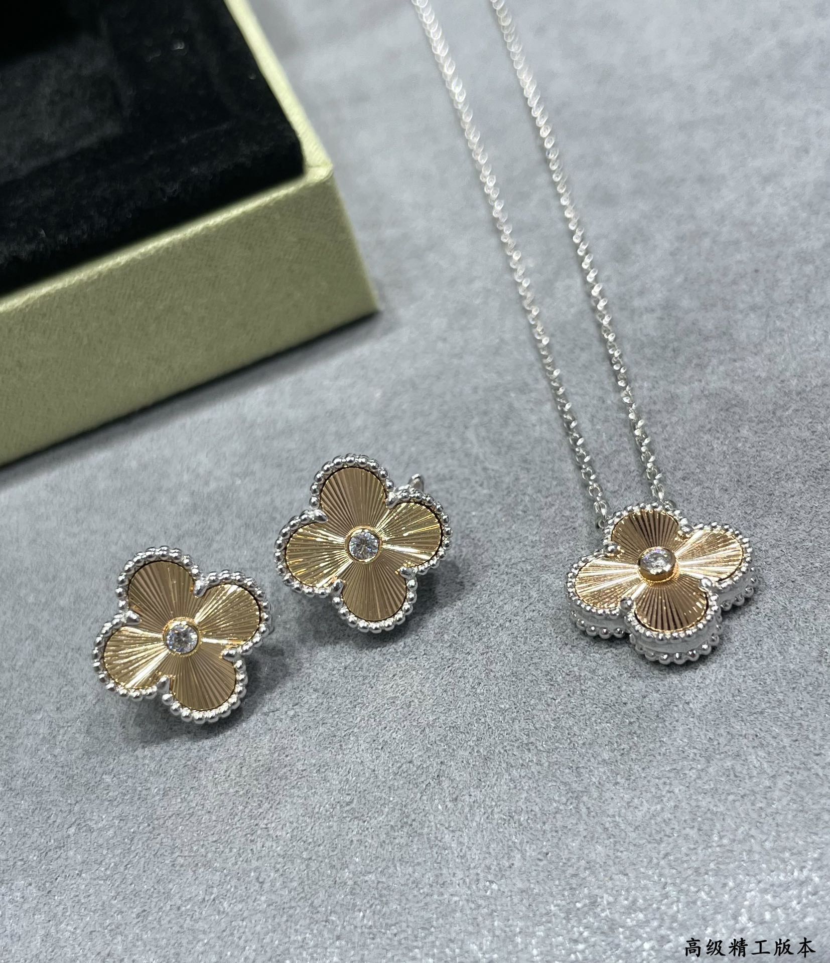 Silver-tone clover flower pendant necklace and matching stud earrings set.
