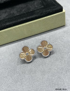 Silver-tone clover flower stud earrings with blue center, pair.