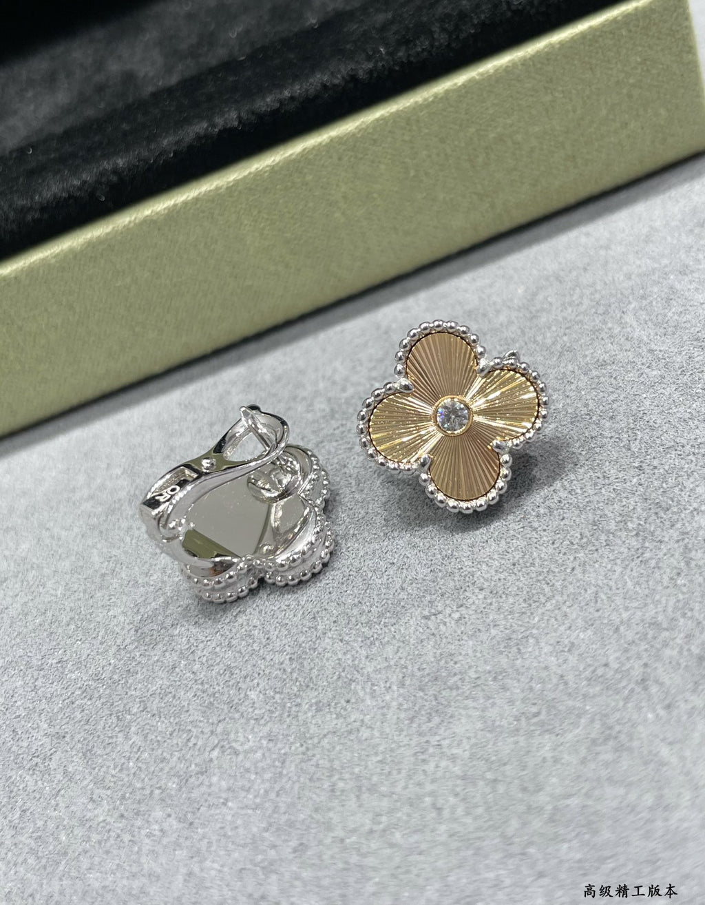 Silver-tone clover flower stud earrings and a silver ring with green stone.