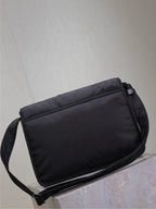 YSL bag with zip-top and shoulder strap, dark padded fabric, minimal front