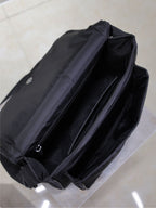 YSL bag open view showing interior lining and zip closure, dark padded fabric