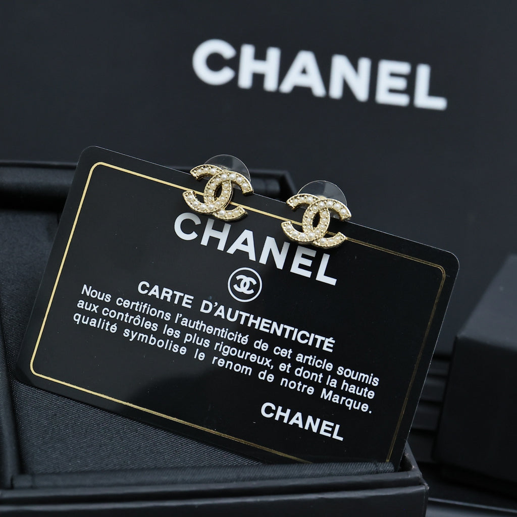 Chanel CC stud earrings on Chanel authenticity card inside jewelry box