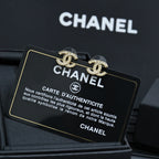 Chanel CC stud earrings on Chanel authenticity card inside jewelry box