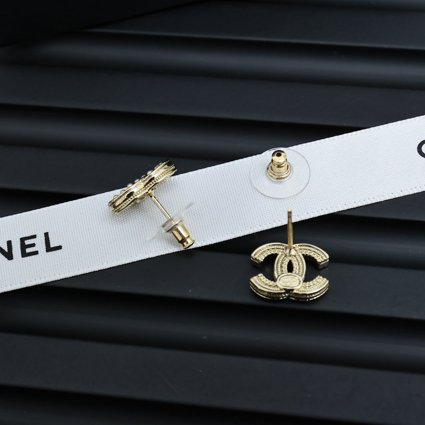 Chanel CC earrings on white ribbon with gold-tone detailing