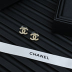 Chanel CC stud earrings in dark jewelry case