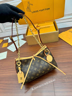Louis Vuitton monogram shoulder bag held by chain strap, tan handles and leather pull