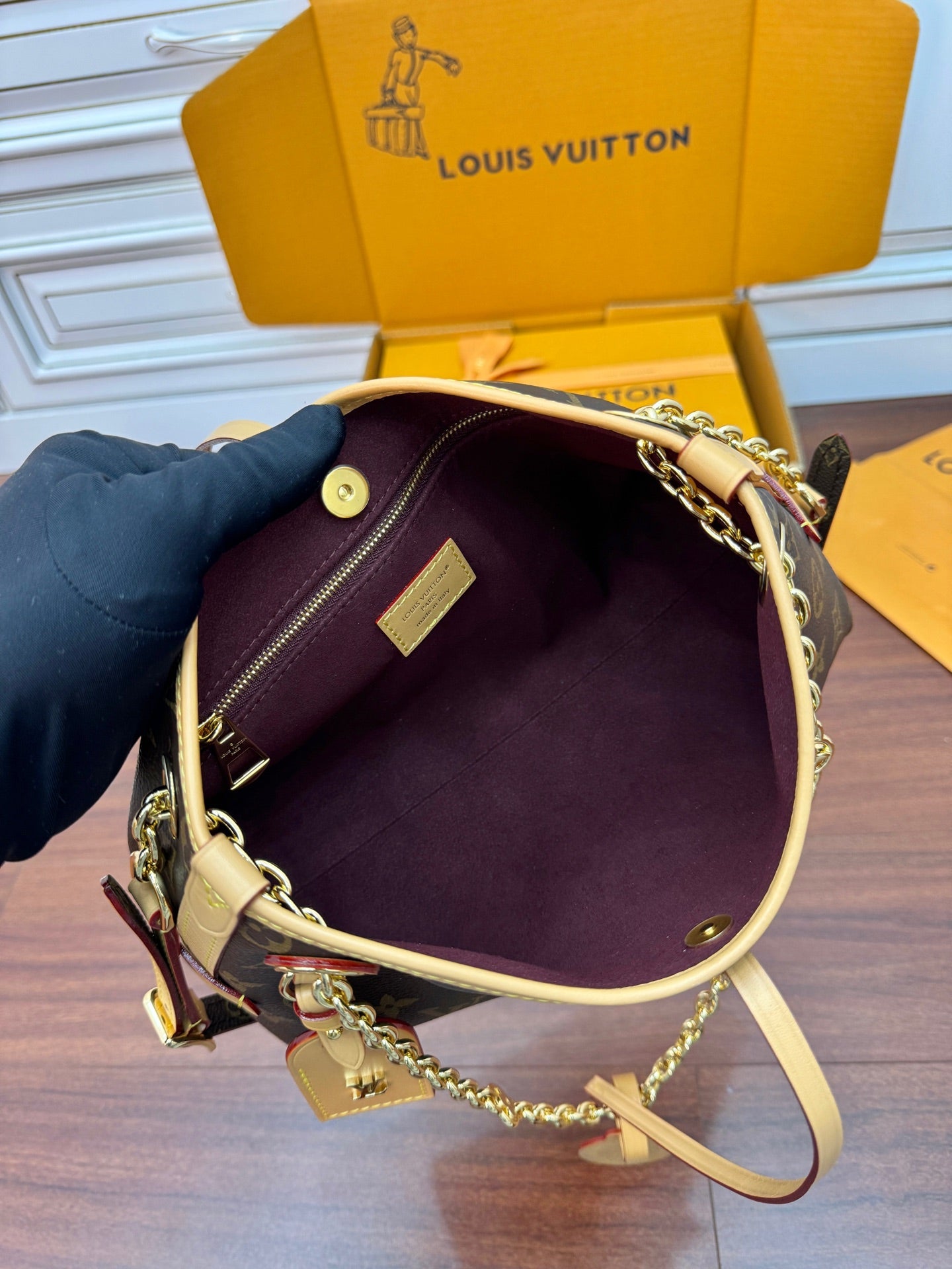 Louis Vuitton monogram mini bag open view showing purple lining and chain strap