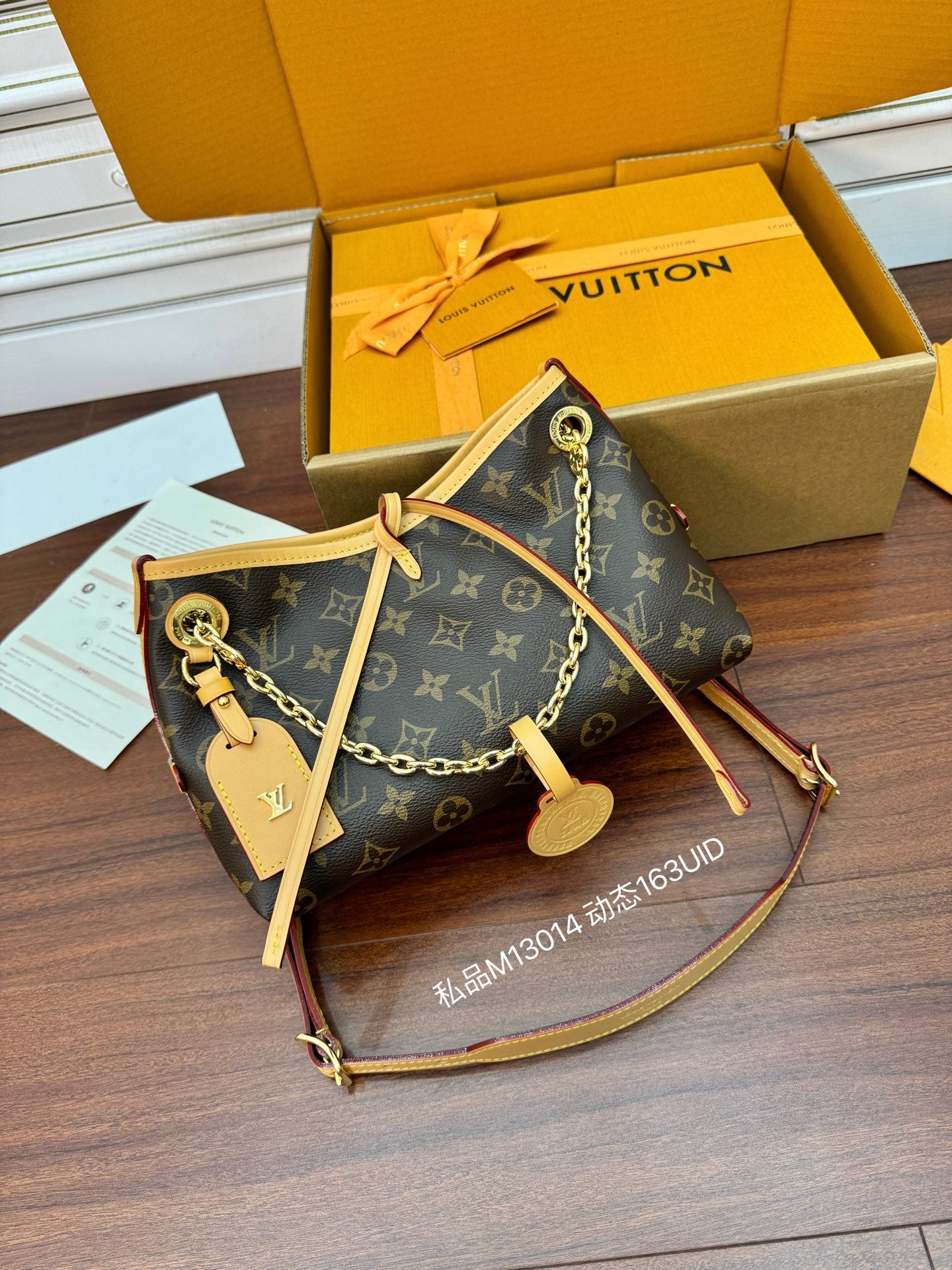 Louis Vuitton monogram mini bag with chain crossbody strap, open top and zipper pull