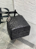 Black Dior mini bag with textured quilted exterior and side ring