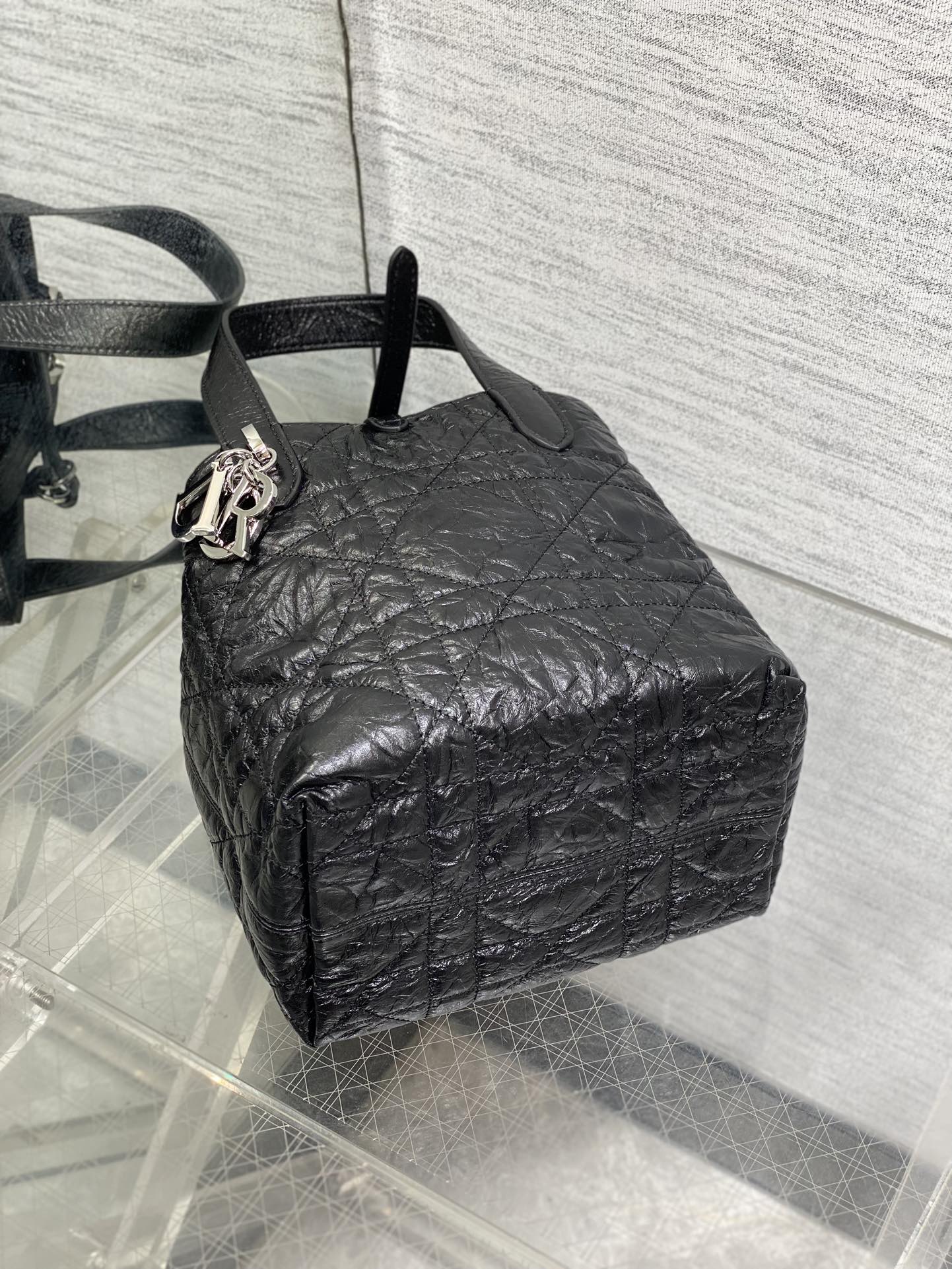 Black Dior mini bag with textured quilted exterior and side ring