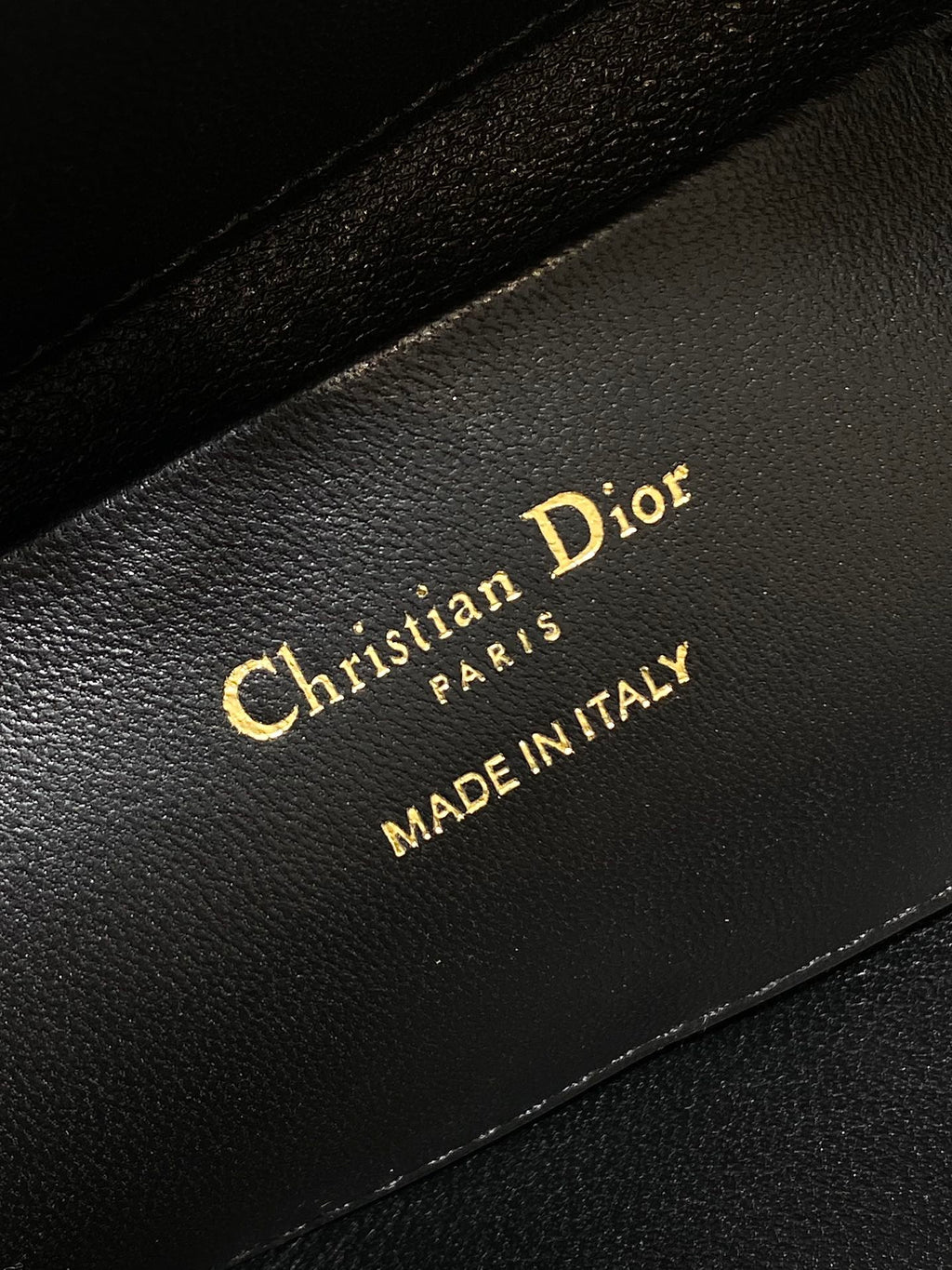 Christian Dior Paris Made in Italy label on black interior