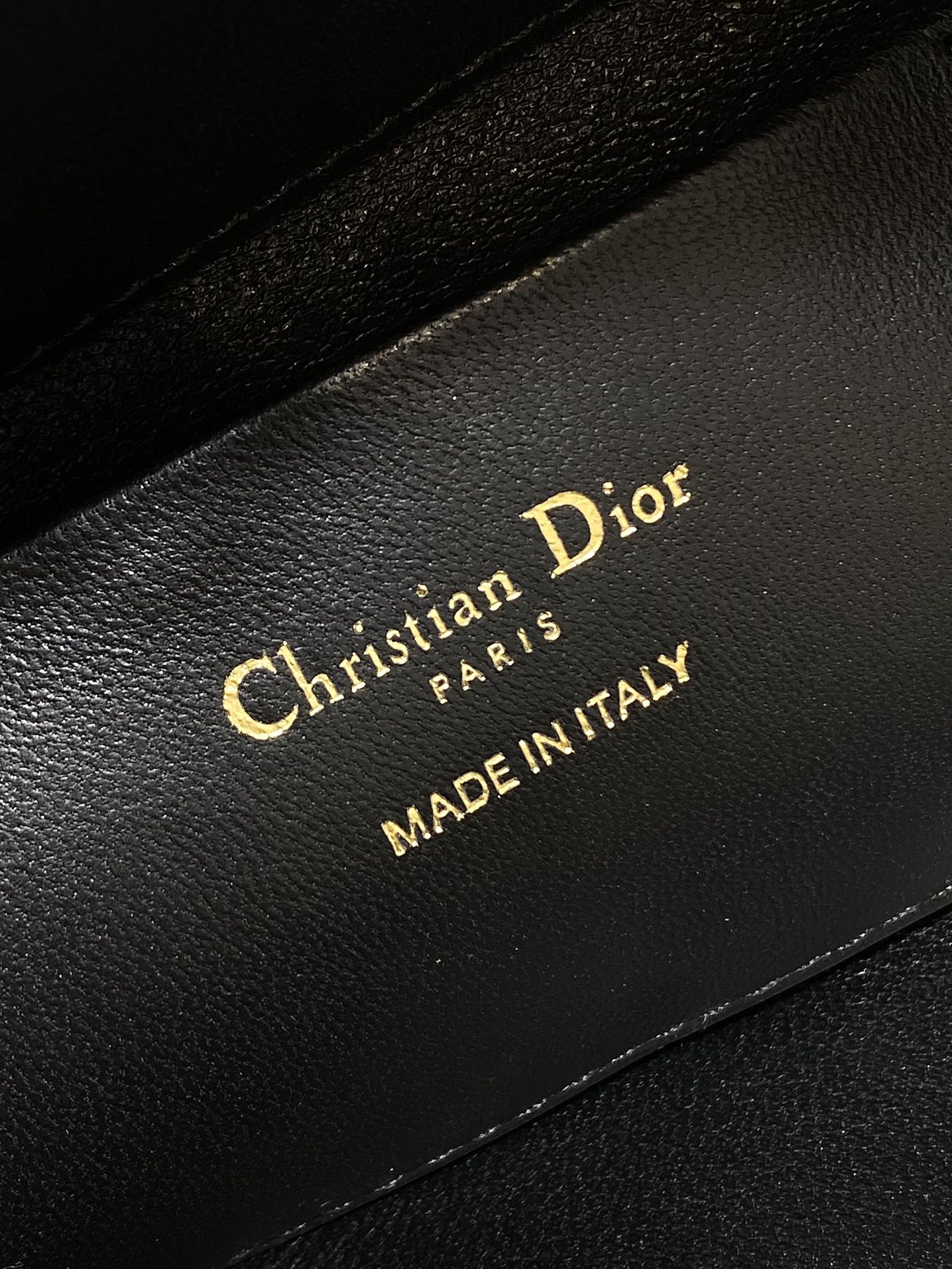 Christian Dior Paris Made in Italy label on black interior