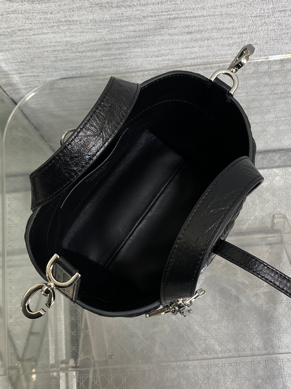 Black Dior mini bag open top showing black fabric-lined interior