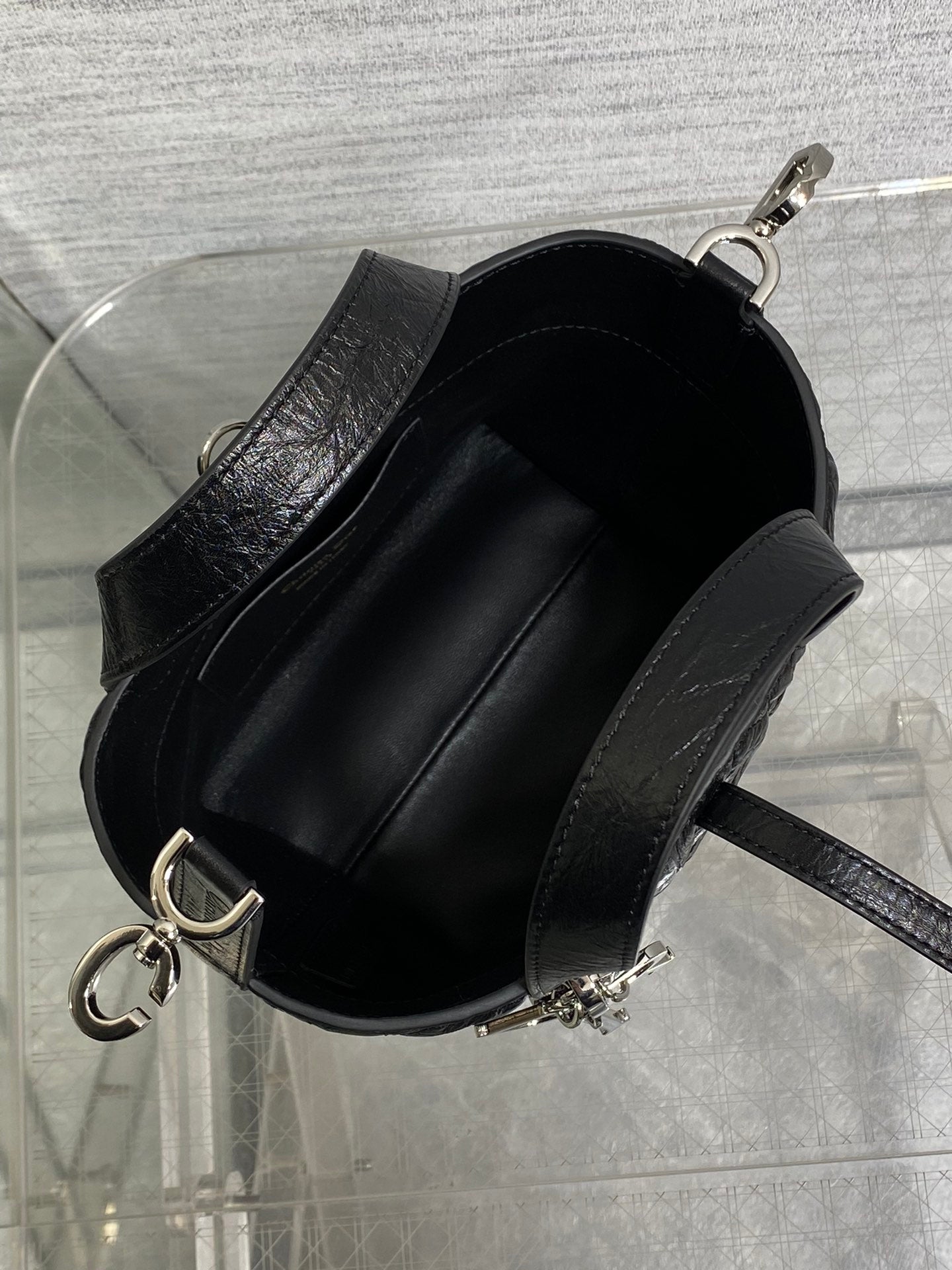 Black Dior mini bag open top showing black fabric-lined interior