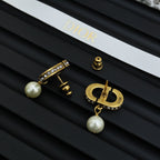 Dior logo earrings, gold-tone with crystal accents and white pearl dangles