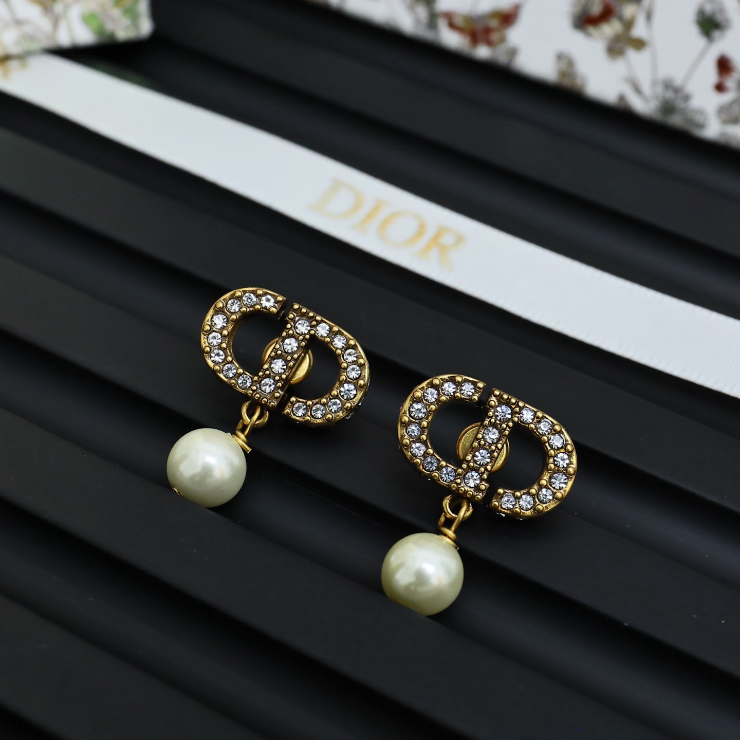 Dior logo stud earrings with crystal border and white pearl drop