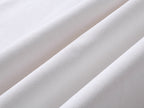 White T-shirt fabric close-up with fine textured weave