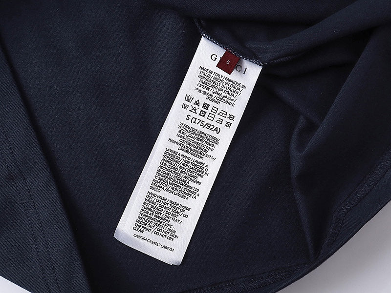 Gucci short-sleeve T-shirt interior neck tag on dark navy fabric