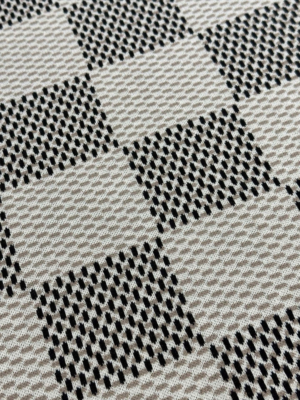 Louis Vuitton check-pattern knit T-shirt fabric close-up with staggered dotted texture