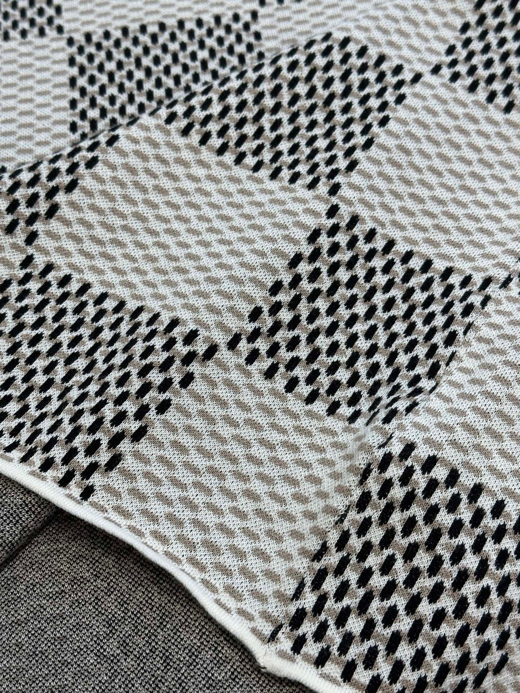 Louis Vuitton check-pattern knit T-shirt fabric close-up with dotted black accents