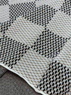 Louis Vuitton check-pattern knit T-shirt fabric close-up with dotted black accents