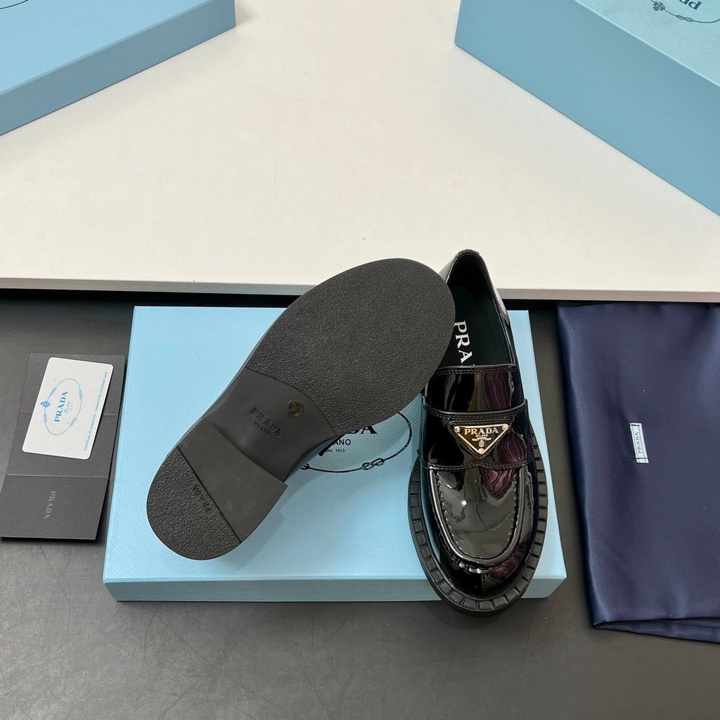 Prada unisex loafers, black patent upper, outsole view with thick tread sole