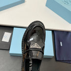 Prada unisex patent loafer close-up in black with adjustable strap and tread sole