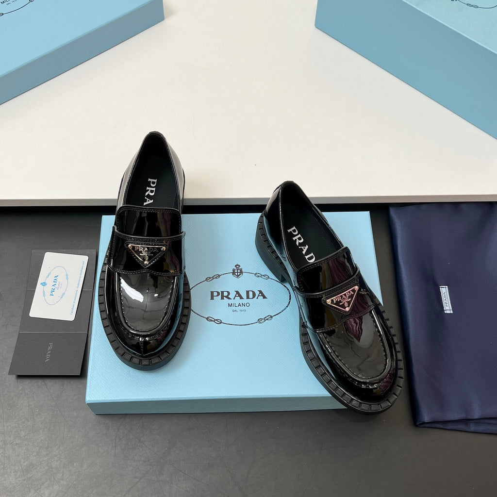 Prada unisex patent loafers in black with chain-like ornament and thick tread sole