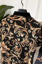 Short-sleeve shirt back view with ornate baroque pattern on black, gold and orange highlights.
